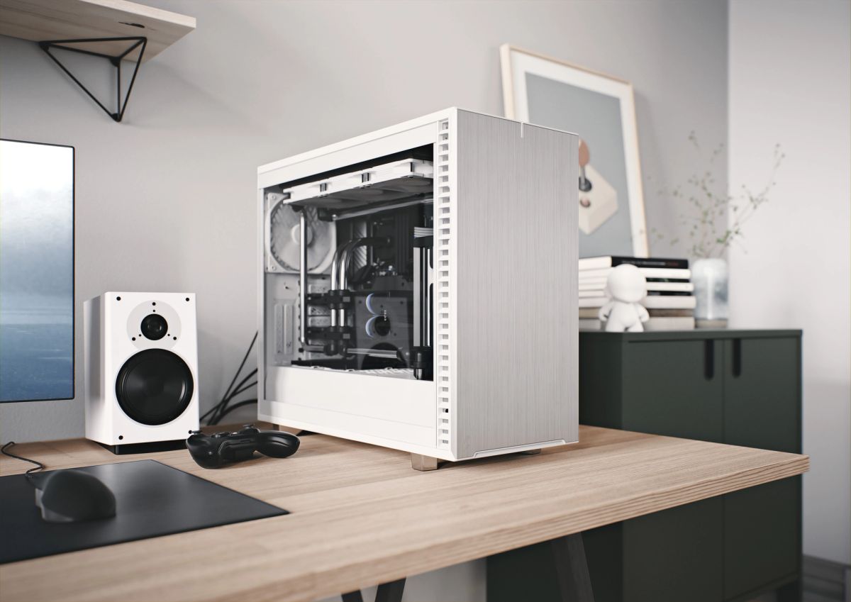 A Fractal Design Define 7 tower on a desk beside a monitor, speaker and game controller.